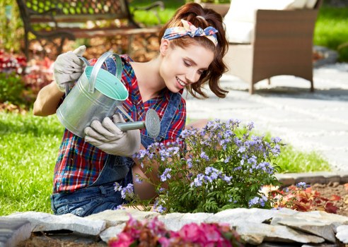 Gardener wearing PPE operating a lawn mower safely